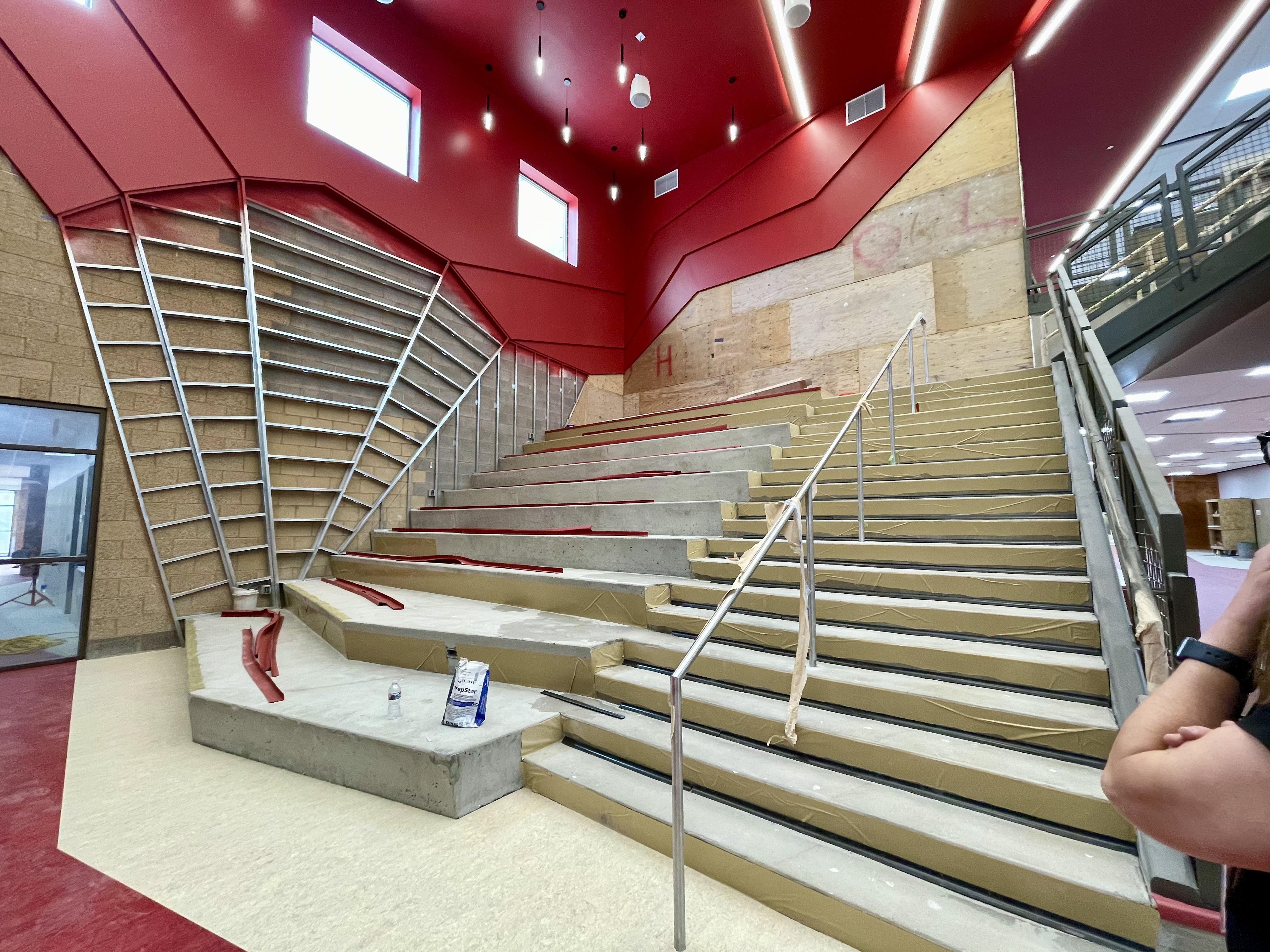 This stairwell doubles as a learning and study space, with tiered seating that faces a wall of monitors. 
