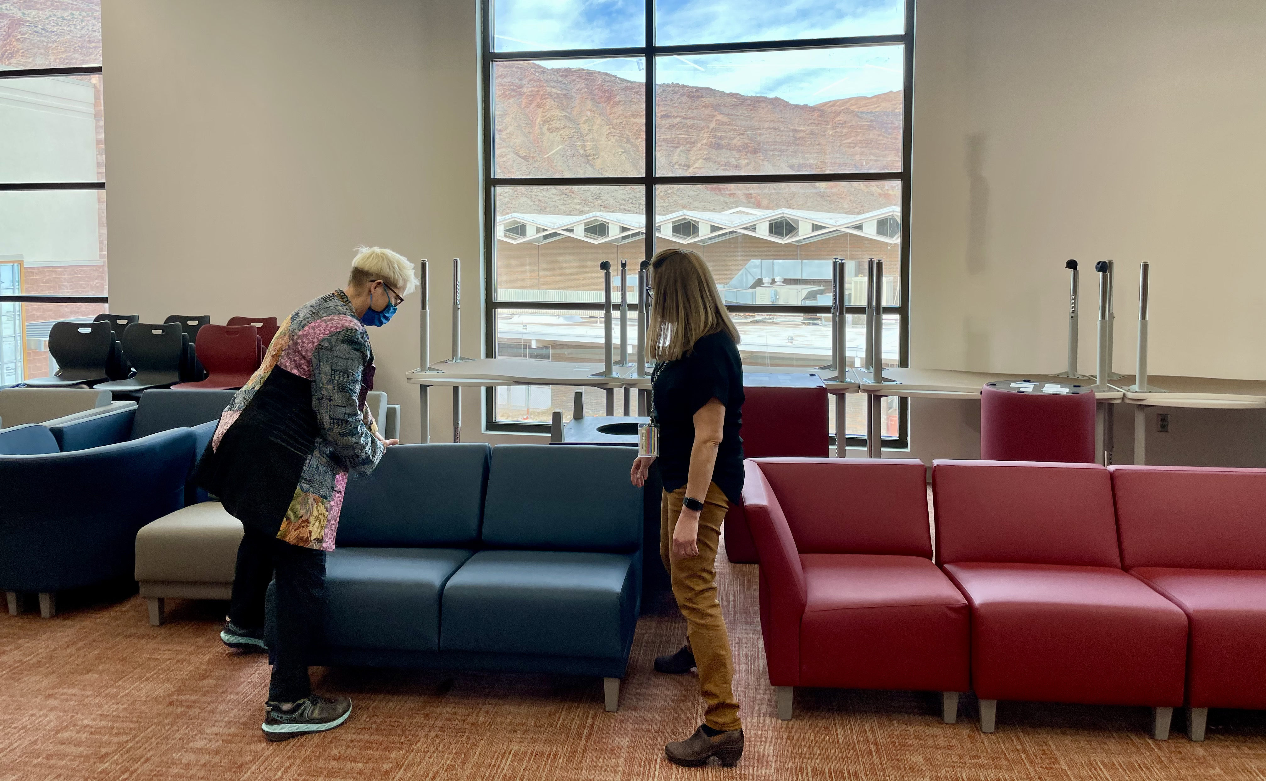 Kay, left, and Elementary School Principal Jill Tatton examine a couch in the media center of the new middle school. 
