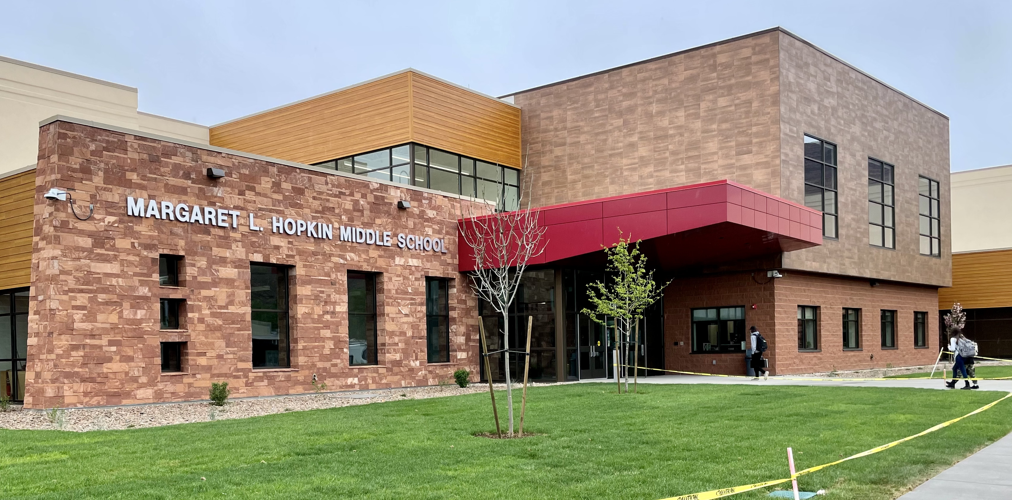 students walk into the Margaret L. Hopkin Middle School on the first day in the new facility