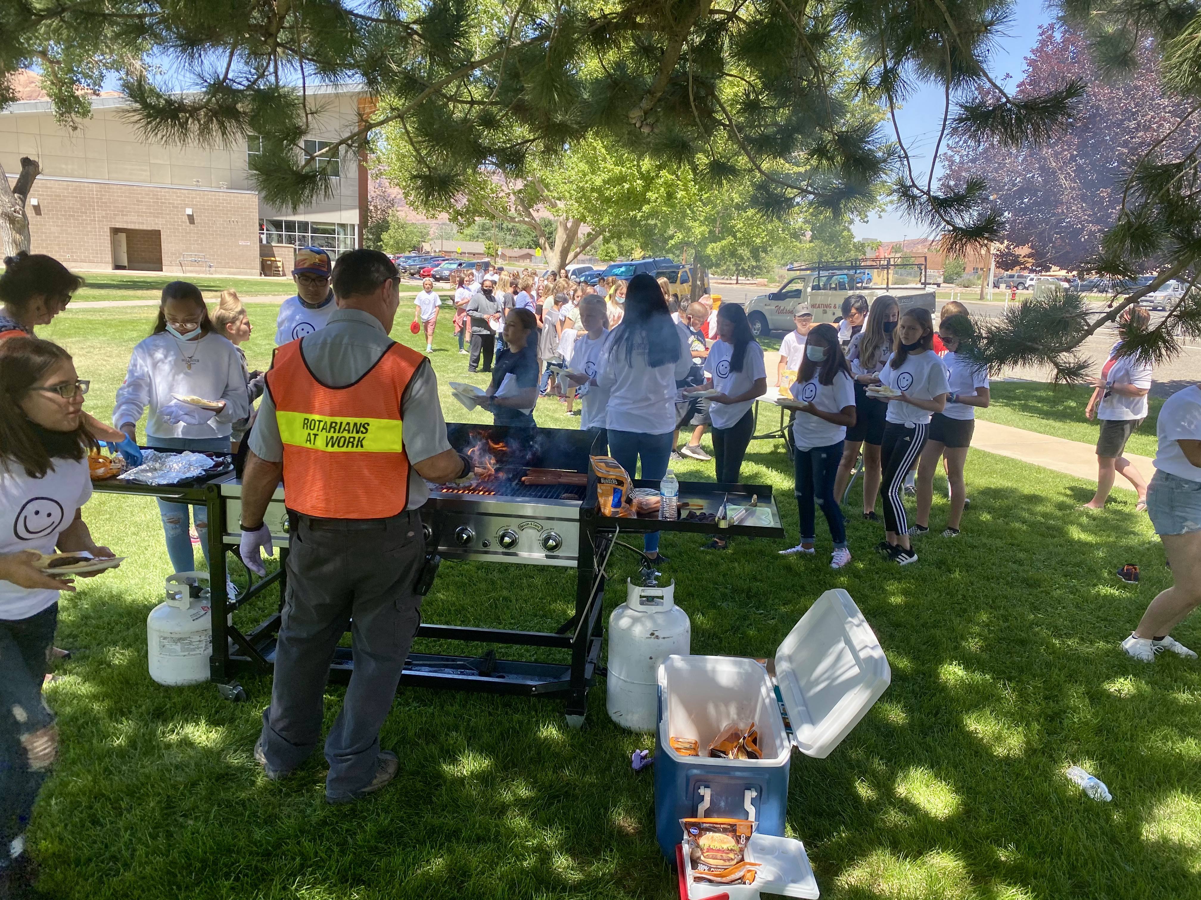 A Rotarian works the grill during a barbecue for middle school students hosted by the Moab Rotary Club. 