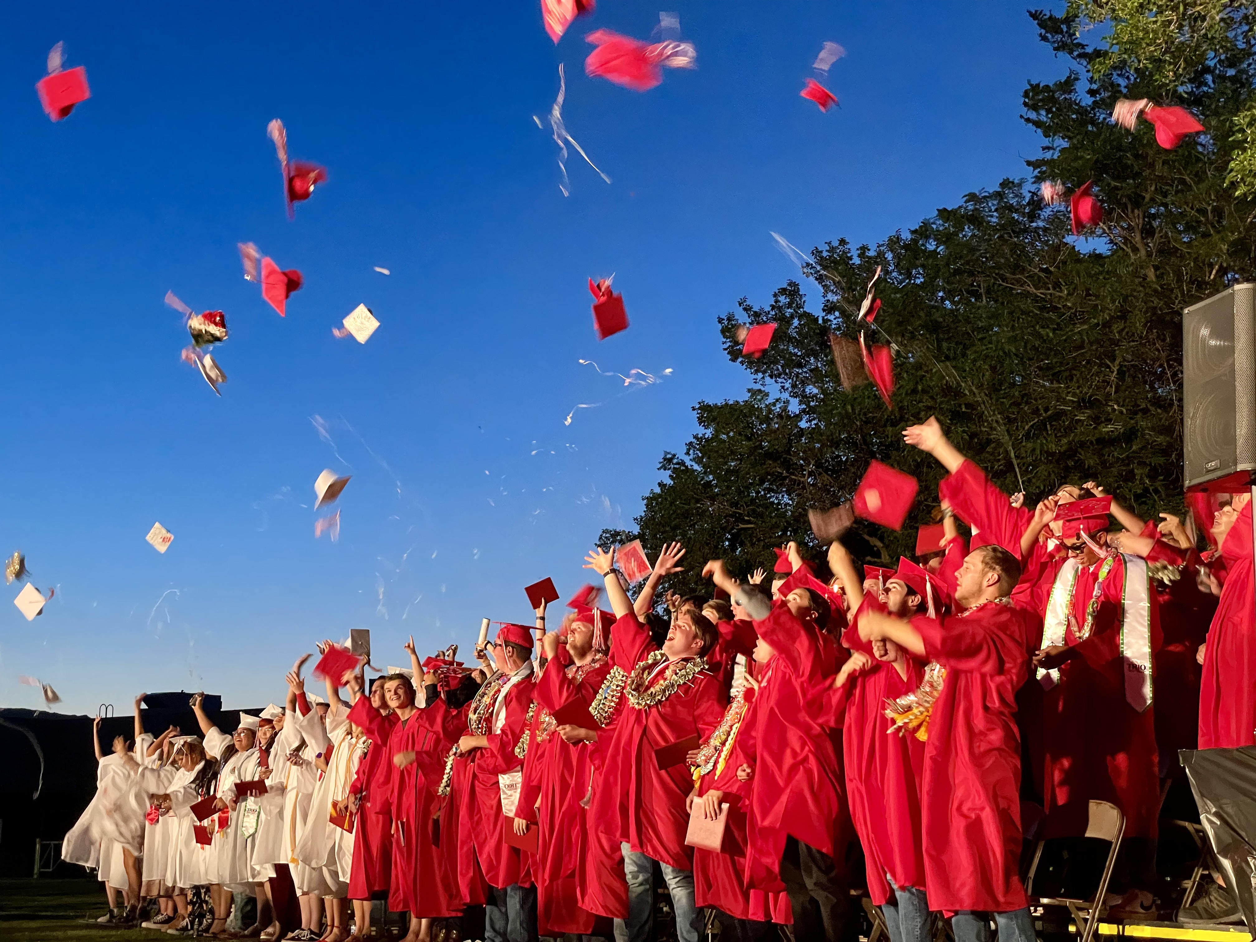 Graduates throw their caps in celebration of putting their primary education to bed. 